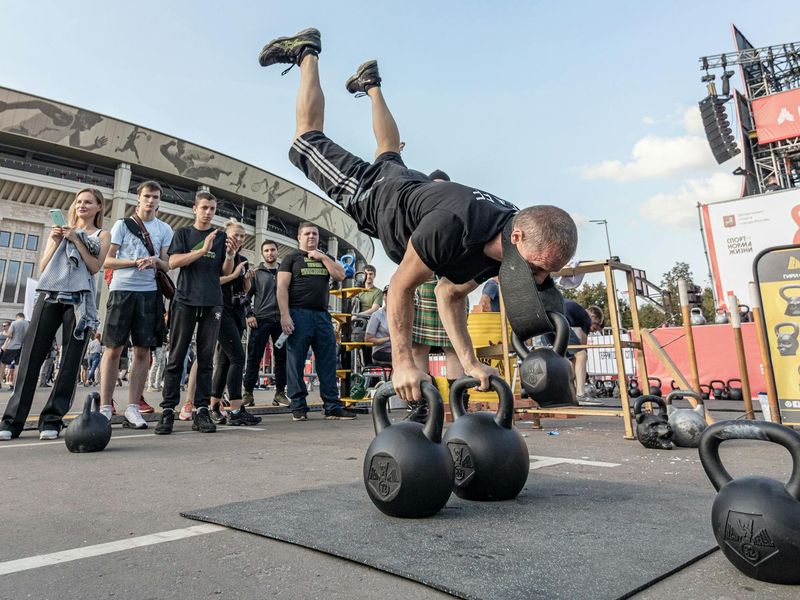 Man performing a controlled bodyweight exercise with intense focus.