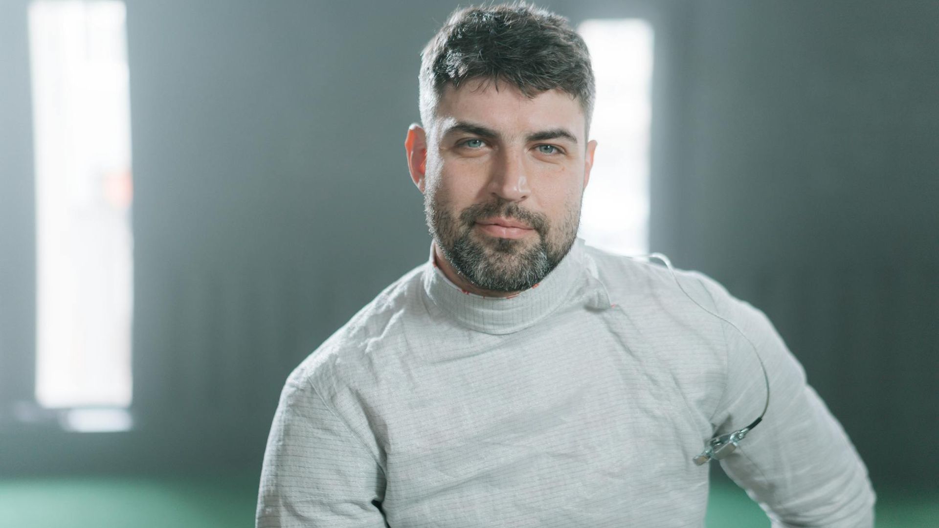 Silhouette of a man in a focused athletic stance.